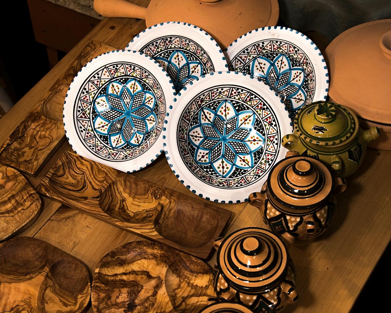 A collection of handpainted dishes and wooden trays showcasing traditional decorative patterns.